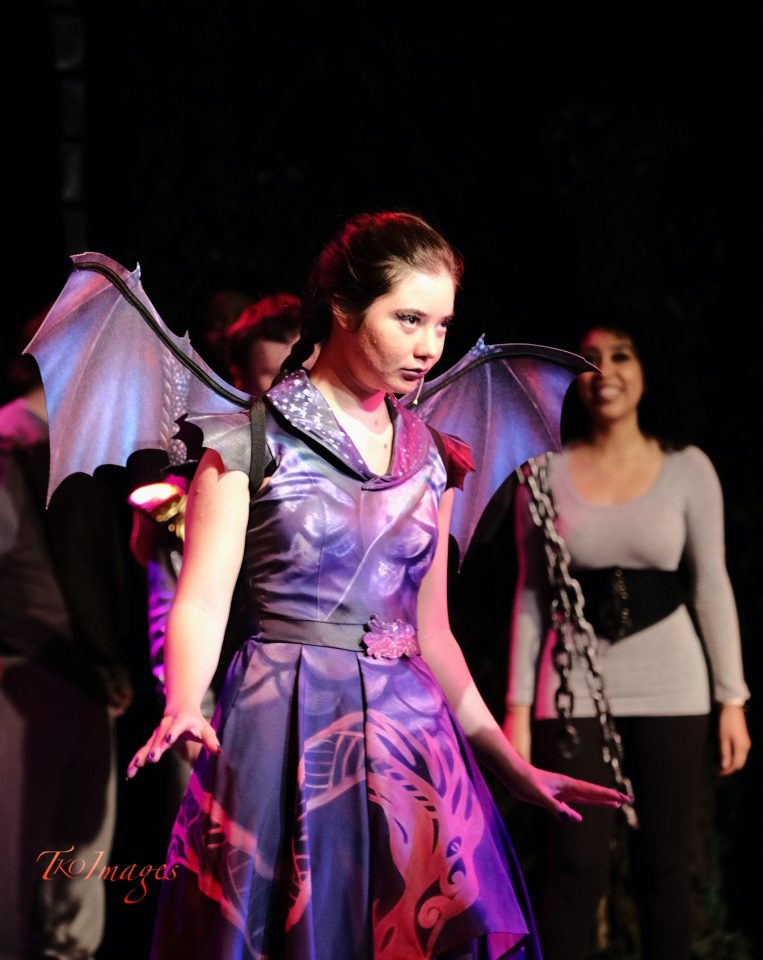 Photo of Karen Lamb wearing a dragon costume on stage