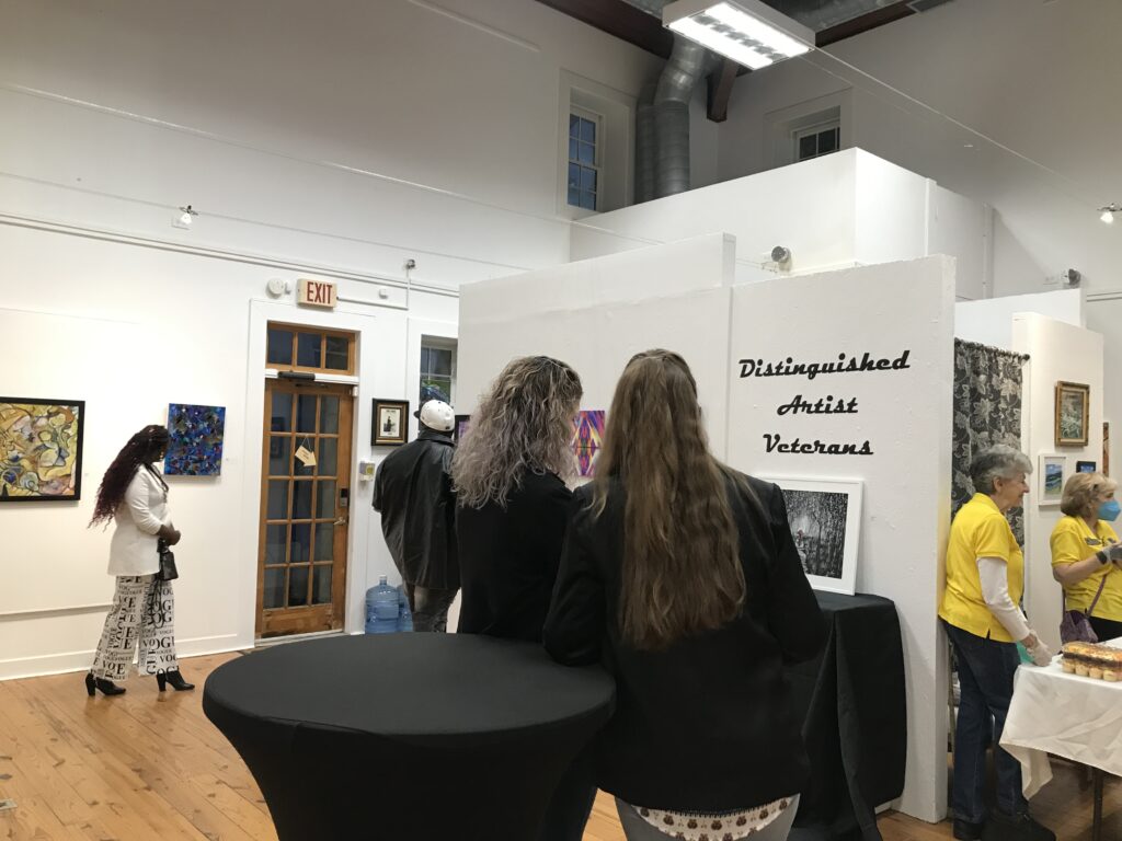 Gallery Wall with the words "Distinguished Artist Veterans Exhibit"