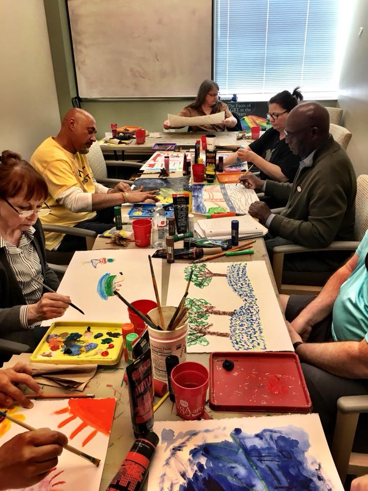 diverse group of veterans make art at a table