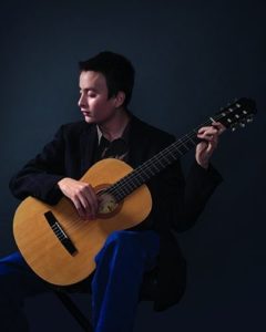 Devin Gutierrez playing acoustic guitar