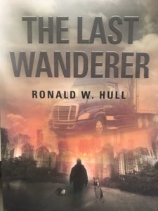 book cover for The Last Wanderer by Ronald W. Hull shows a cloudy post-apocalyptic city skyline ablaze with translucent overlays of a tractor-trailer, a man with his back turned, a German shepherd, and a chimpanzee in the foreground