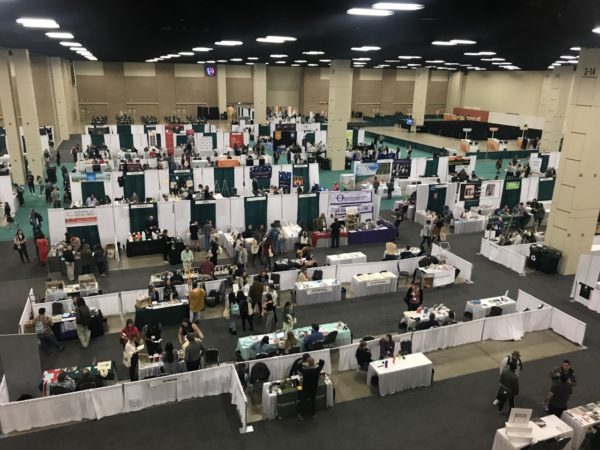 A balcony view of tables down below at the AWP Book Fair