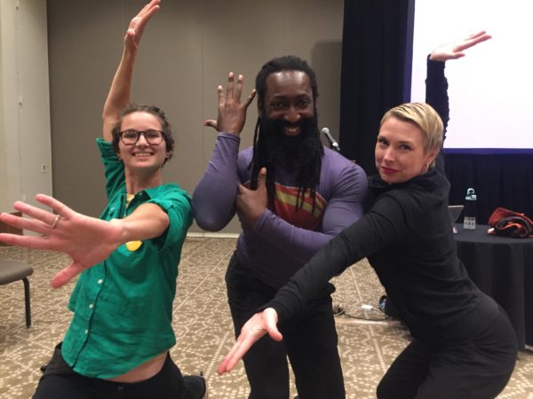 Three people striking dance poses.