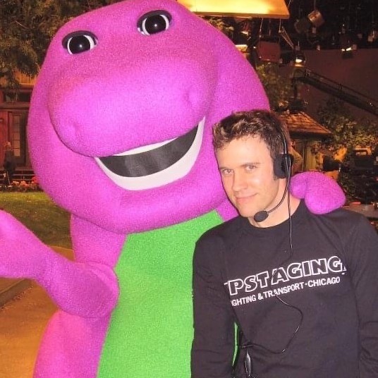 David Voss standing next to Barney the Dinosaur