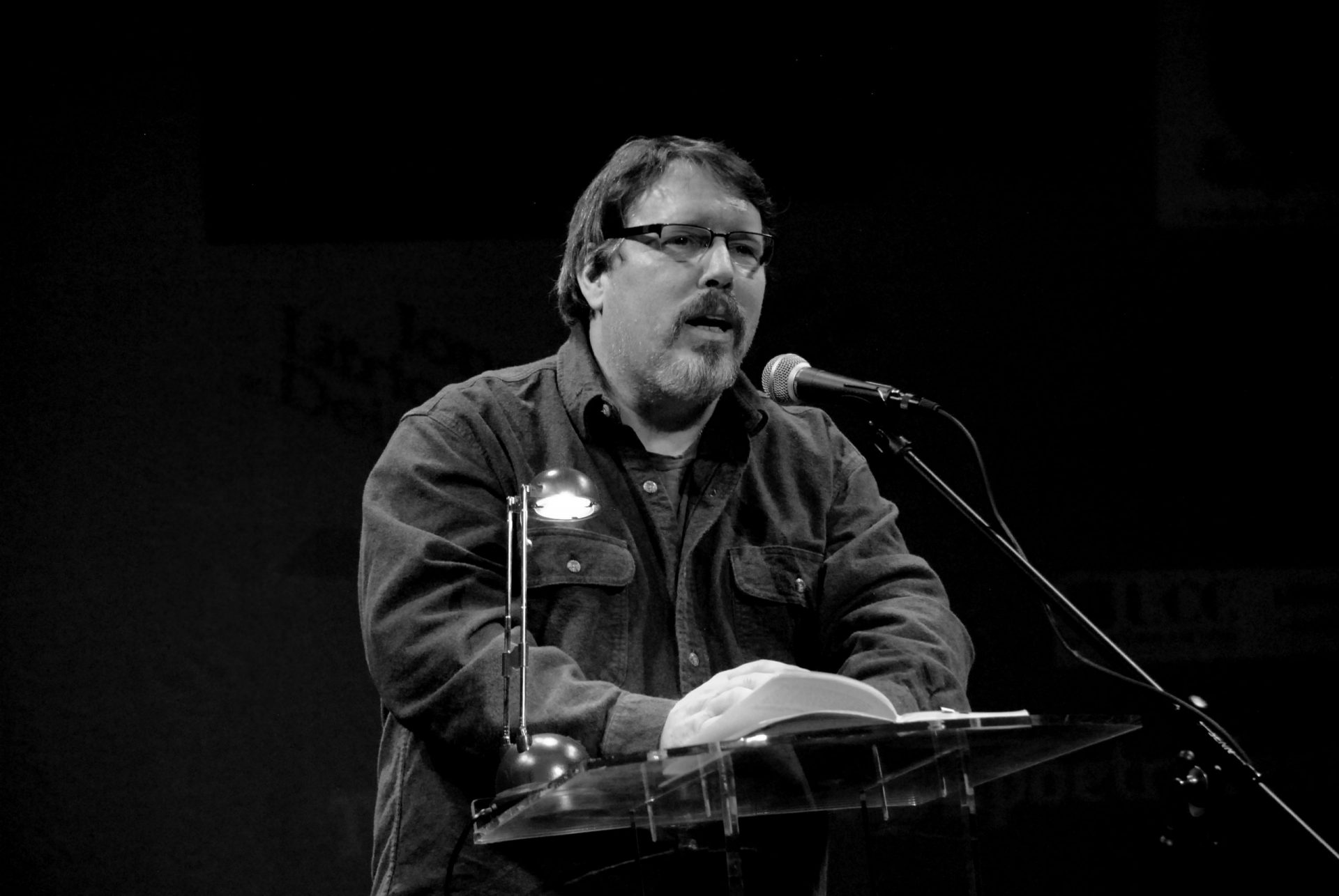 Author Brian Turner reads at a microphone
