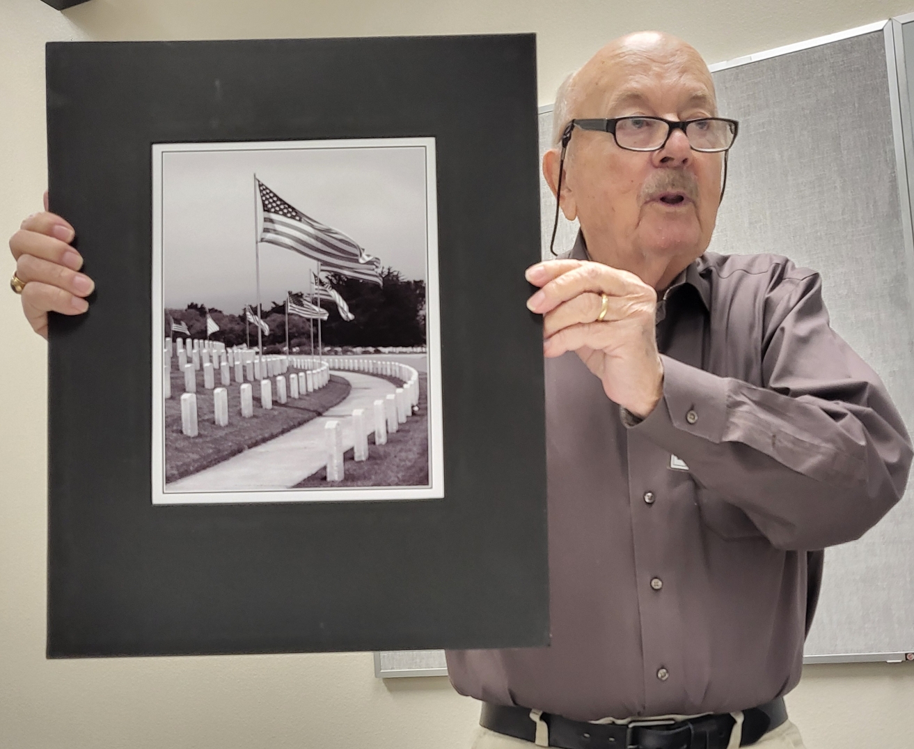 Wes O'dell holds up his original film photography portrait at the 16th Annual Veterans Exhibit Panel at the Williamson County Public Library with Art Spark Texas