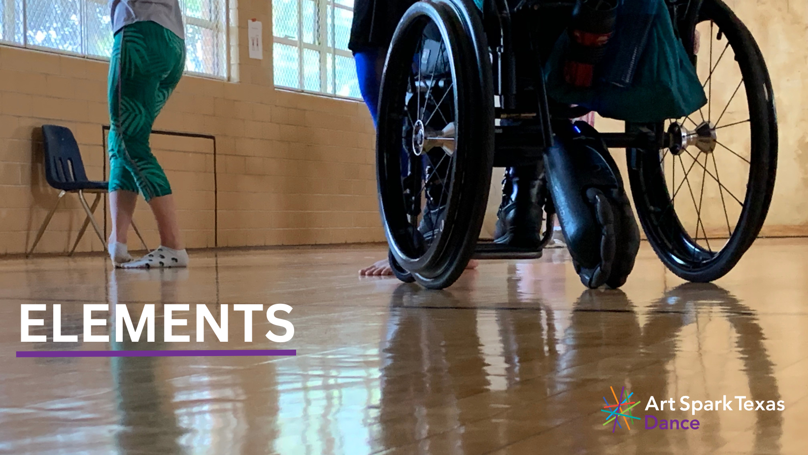 One dancer's feet and one dancer's wheels in a dance studio. Text reads, "Elements."