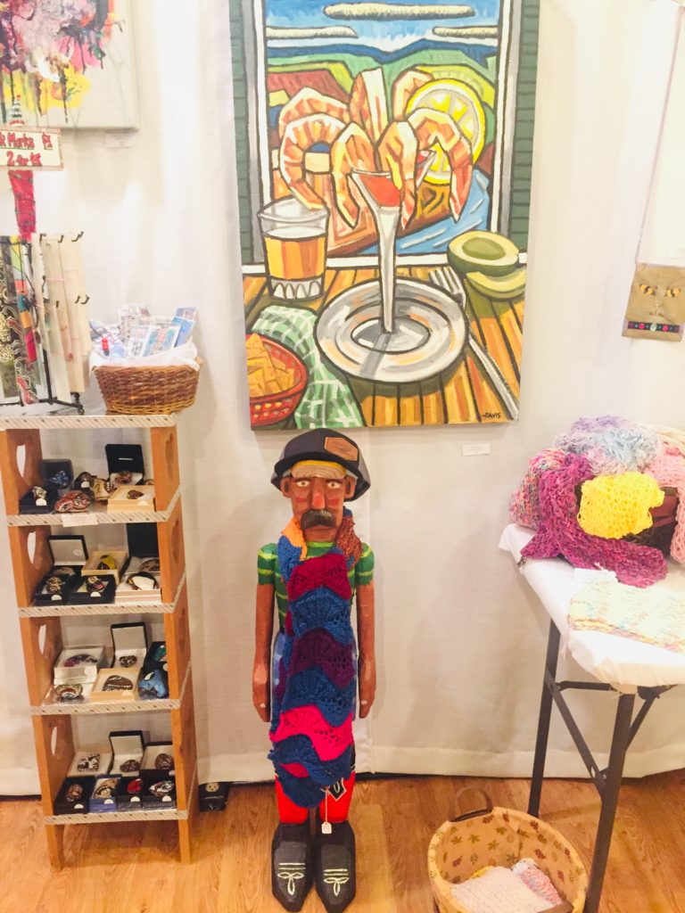 wood carved man and shrimp cocktail painting