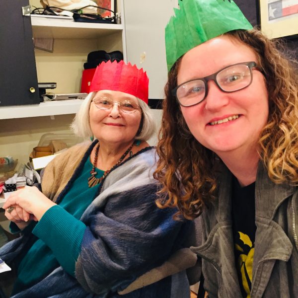 April and Lynn take a selfie with paper Christmas crowns