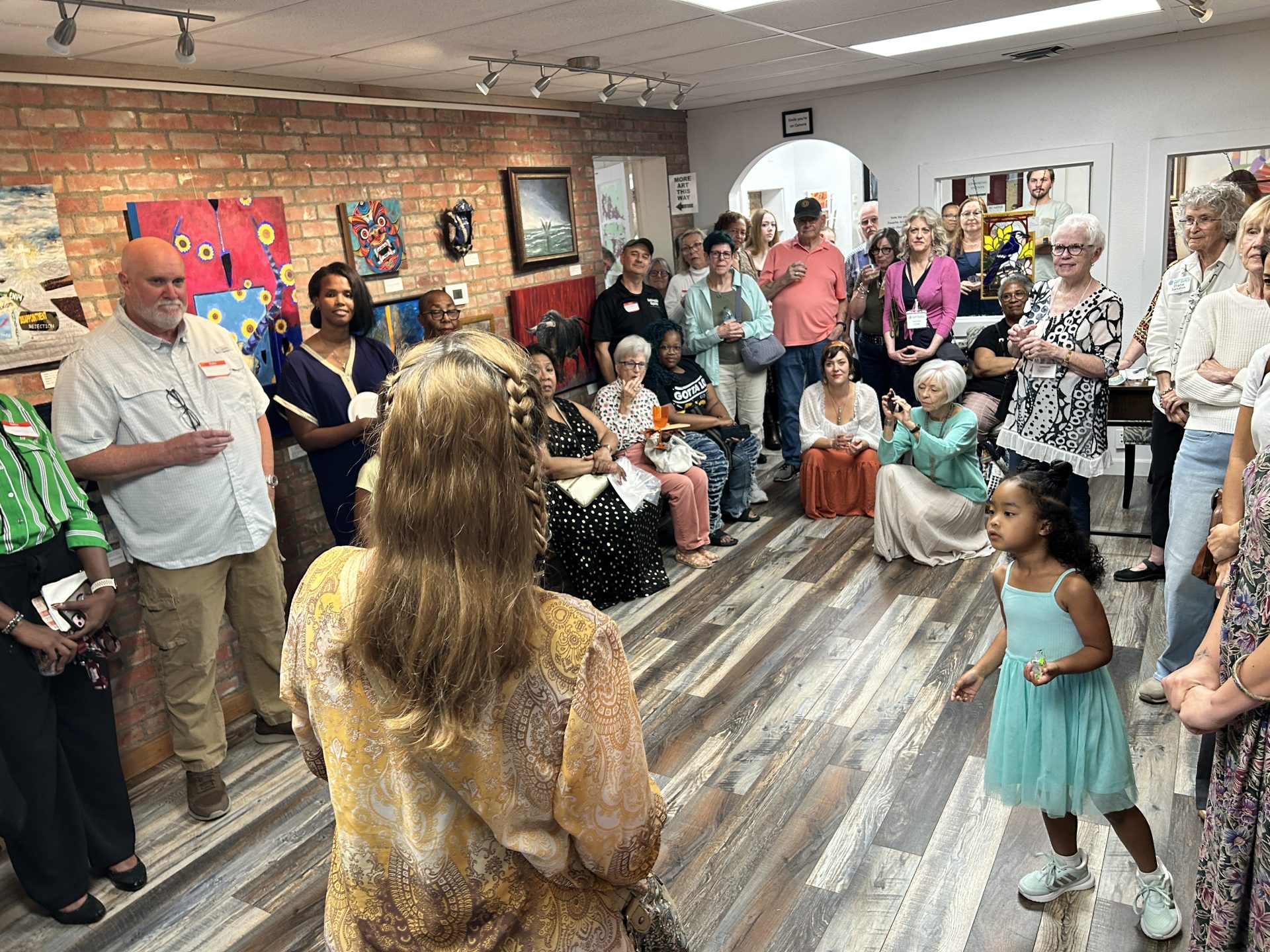 Veterans during an artist talk at theopening reception of the 16th annual distinguished artist veterans exhibit in georgetown texas at the williamson county art guild gallery during veterans month