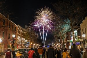 Fireworks appear high in the sky above historic buildings in Alexandria, Virginia