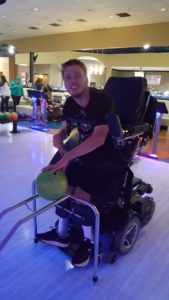 Michael bowling in standing wheelchair