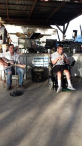 michael in a wheelchair performing at an open mic with his brother