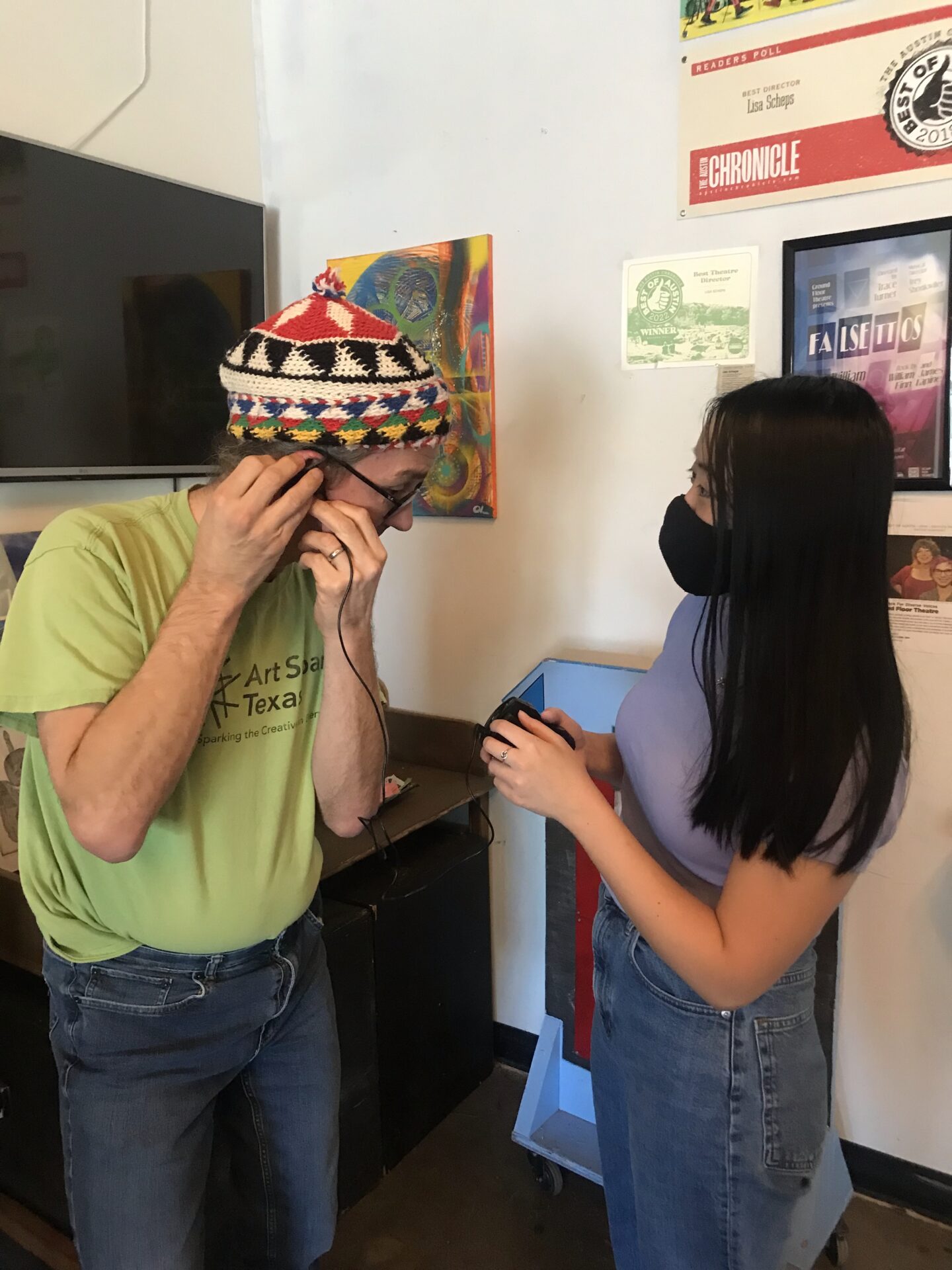 Art Spark Texas volunteers engaging with audio description gear to transcribe audio for blind attendees of movies, theatre shows, museums and more.