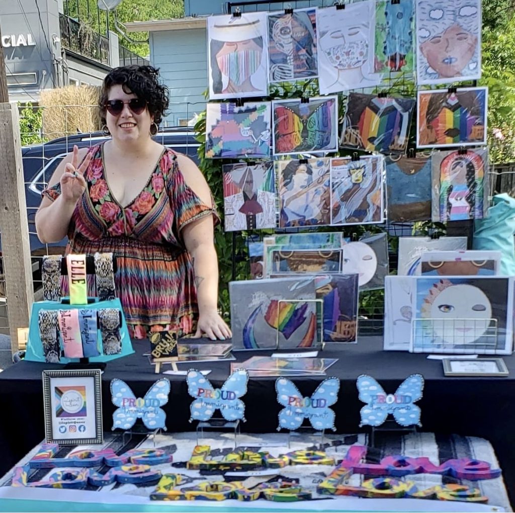 An artists selling their work at a craft fair.