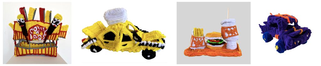 On the left, a Corn Dog carnival stand sculpture. In the center, one sculpture of a yellow cab car and another sculpture of French Fries, a Hamburger and tall soda from What-a-Burger restaurant. On the right, a purple hot rod car sculpture. All sculptures are made from pipe cleaners.