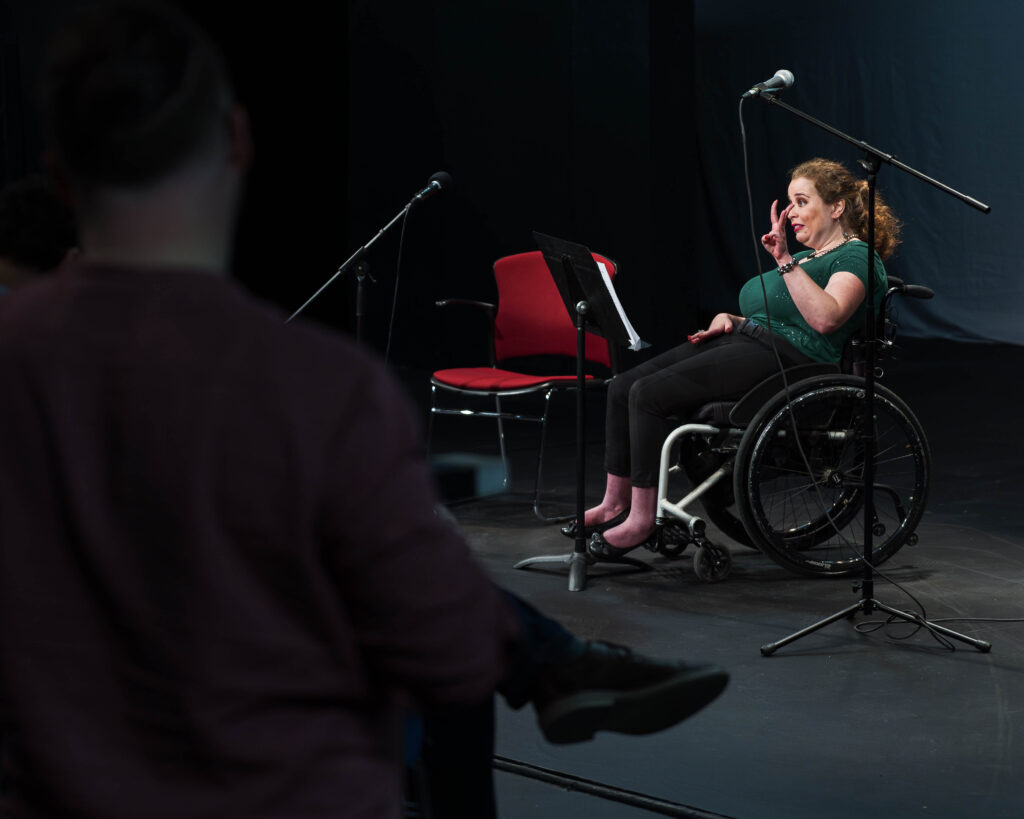 Speaking Advocates Participant tells her story on stage for the Showcase from Art Spark Texas