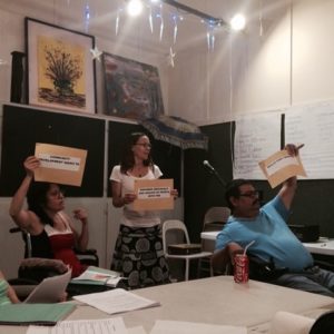 Art Spark Texas board members hold up signs as part of a brainstorm session