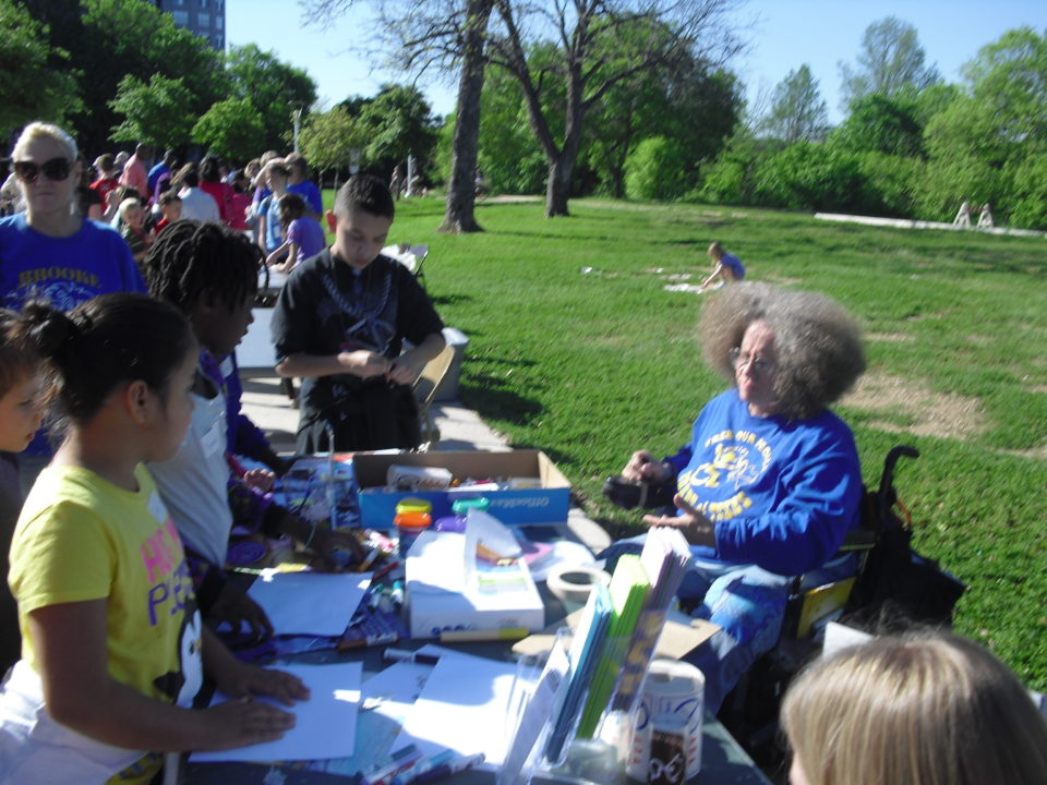 Adapt volunteers running an art activity booth at the MACC