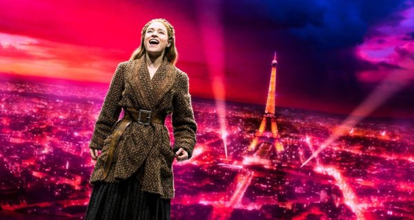 Anastasia singing with the Eiffel Tower in the background