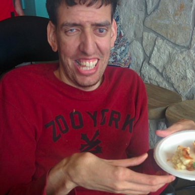 An individual poses with a plate of food