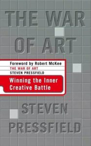 The author/title of Steven Pressfield’s The War of Art appears over a background of gray squares with three small mirrors embedded amongst the squares.