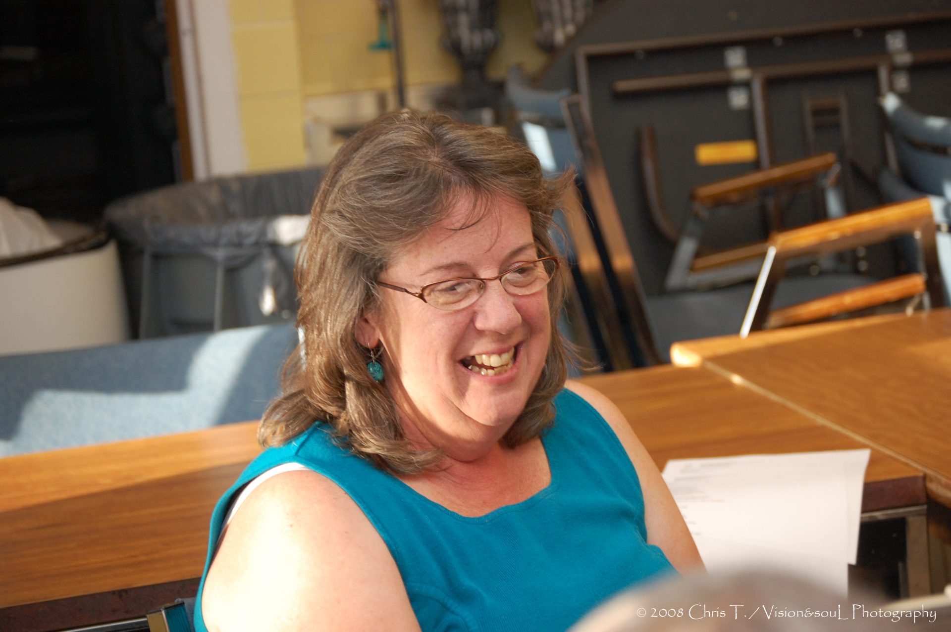 Chris Strickling smiling wearing a blue shirt and glasses in the Actual Lives program with Art Spark Texas