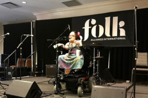 Gaelynn Lea performing on stage at the FOLK ALLIANCE INTERNATIONAL CONFERENCE