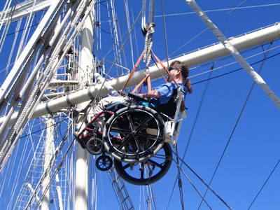 Gene in wheelchair suspended from a rope