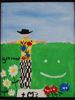 Man in a brightly colored shirt looking over a tall hedge