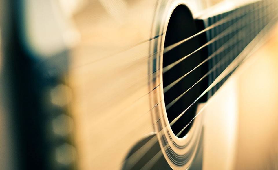 Close-up photo of acoustic guitar strings.