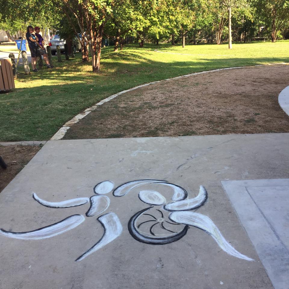 chalk drawing of the Body Shift logo, which is a stylized version of a dancer using a wheelchair with another dancer