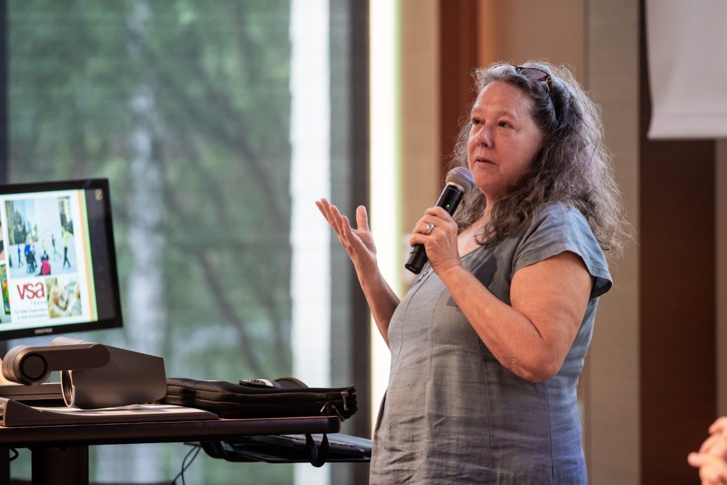 Celia Hughes speaking at the University of Texas when Art Spark Texas was VSA (Very Special Arts) of Texas