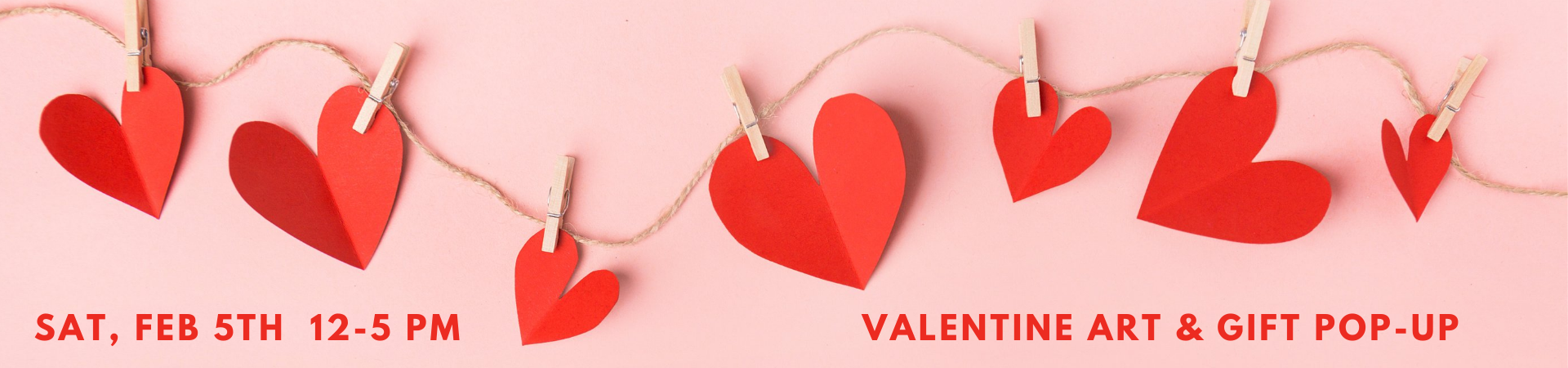 A string of red paper hearts on a clothesline