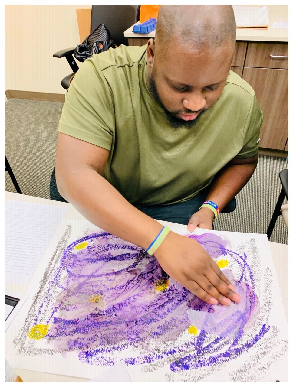 man using chalk to create art on paper